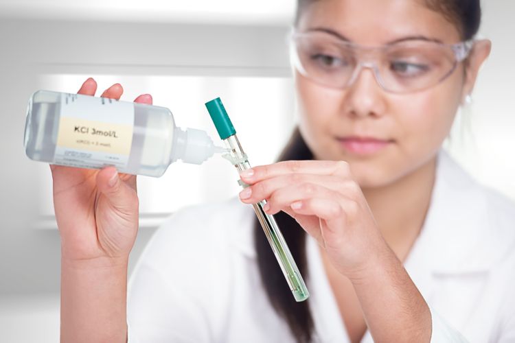 female lab worker refilling 60750100 reference electrode