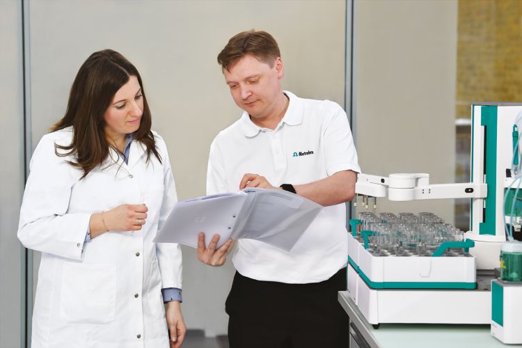 Service engineer in discussion with laboratory personnel