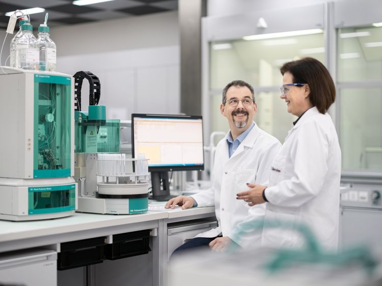 lab workers sat by computer