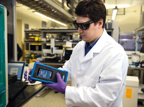 Man with Raman spectrometer in the hands