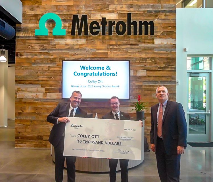 Dr. Colby Ott (center) receiving the Metrohm USA Young Chemist Award in 2022.