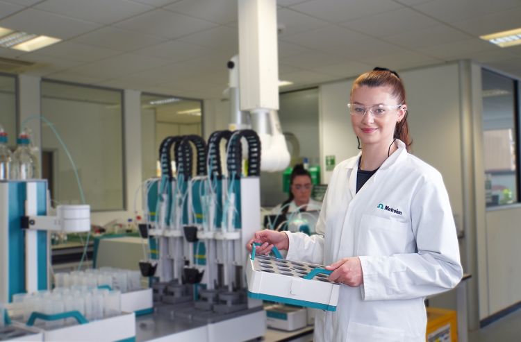 woman holding sample beakers