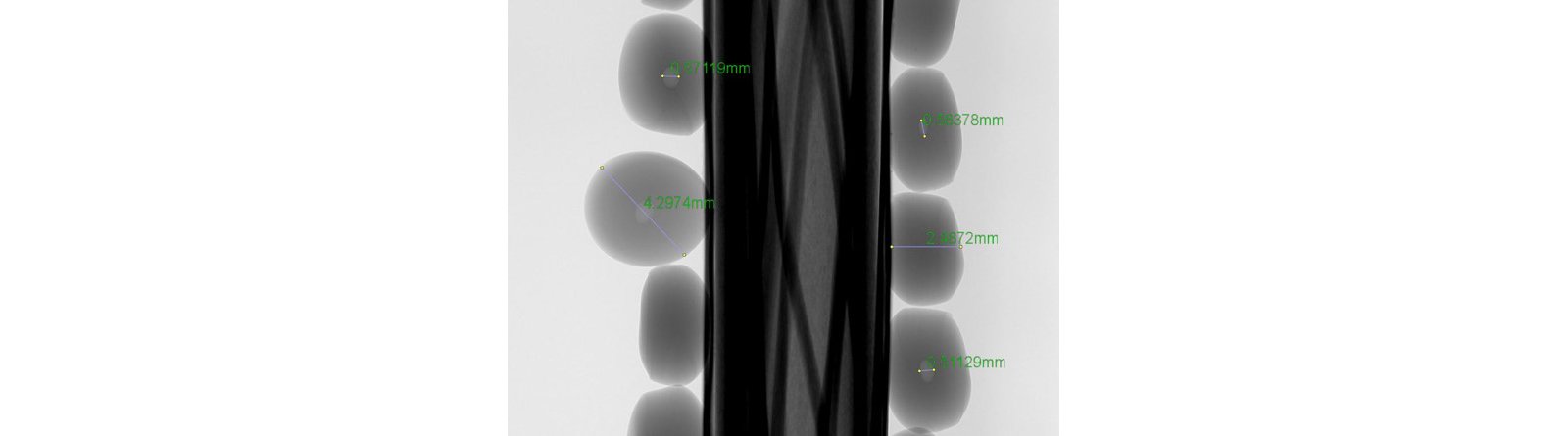Example   of   computer   tomography   (CT)   scan   of   polyethylene  pellets  showing  air  bubbles  inside  the  polymer  granulate.