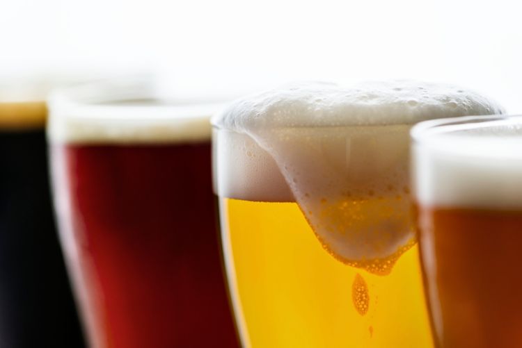 Close-up image of a variety of beers in glasses.