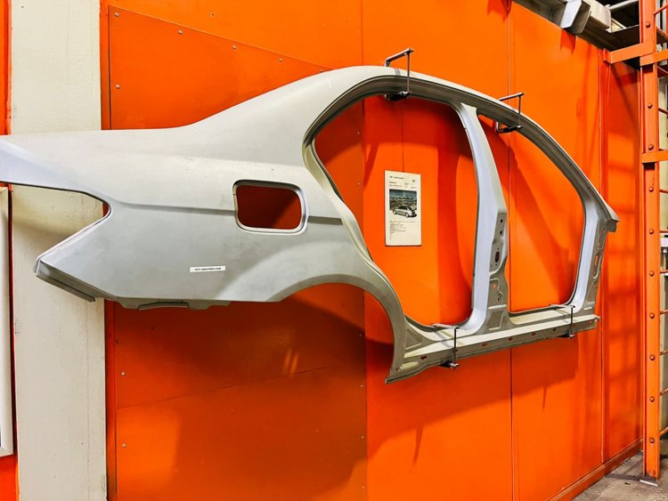 car chassis hung on an orange wall