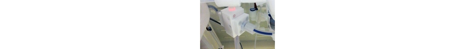 Non-invasive clamp-on flow cell with optical fibers (in blue) attached to the wet bench circulation stream. Note the protective and purged tube around the fiber, preventing corrosion.