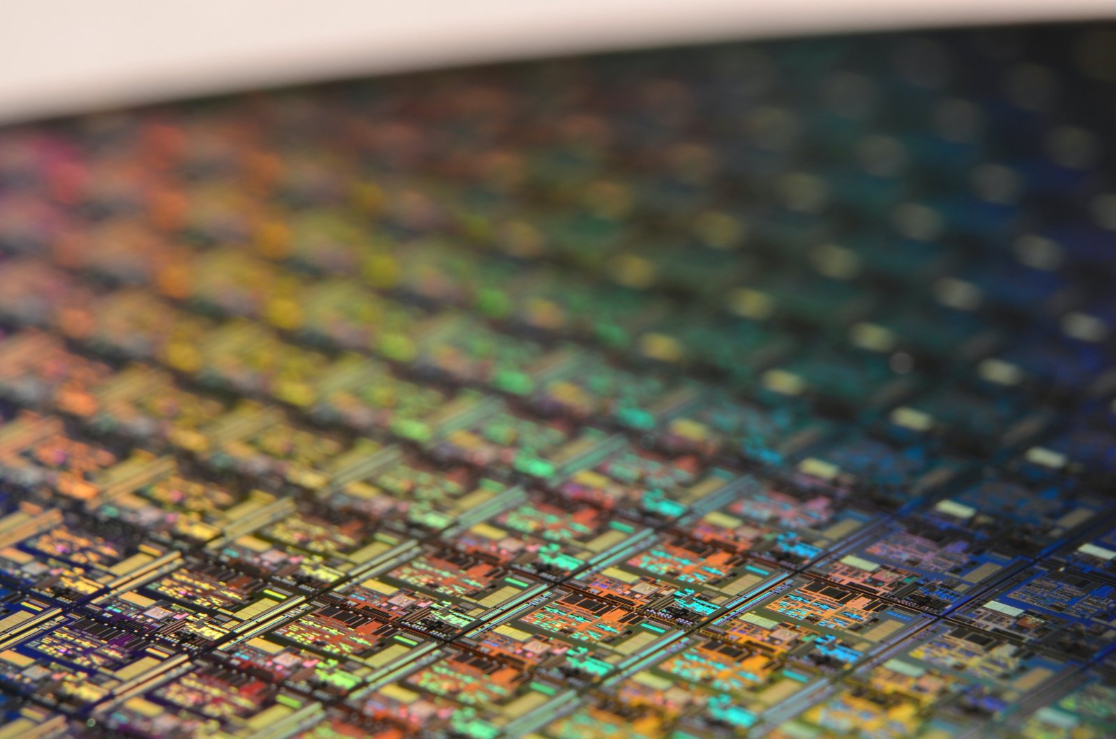 Close-up view of a silicon wafer. Each miniature square is a chip with microscopic transistors and circuits.